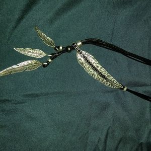 Silver colored feather necklace